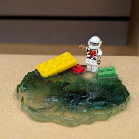 Green terrain with block and mini toy figure resin coaster